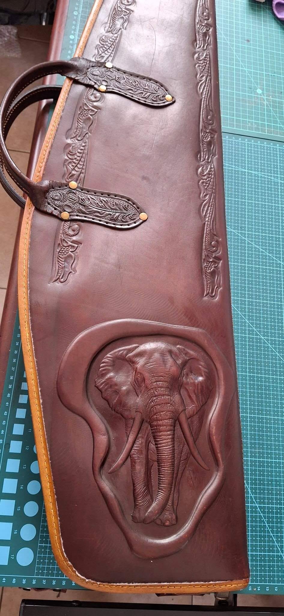 Brown leather sling with an embossed elephant