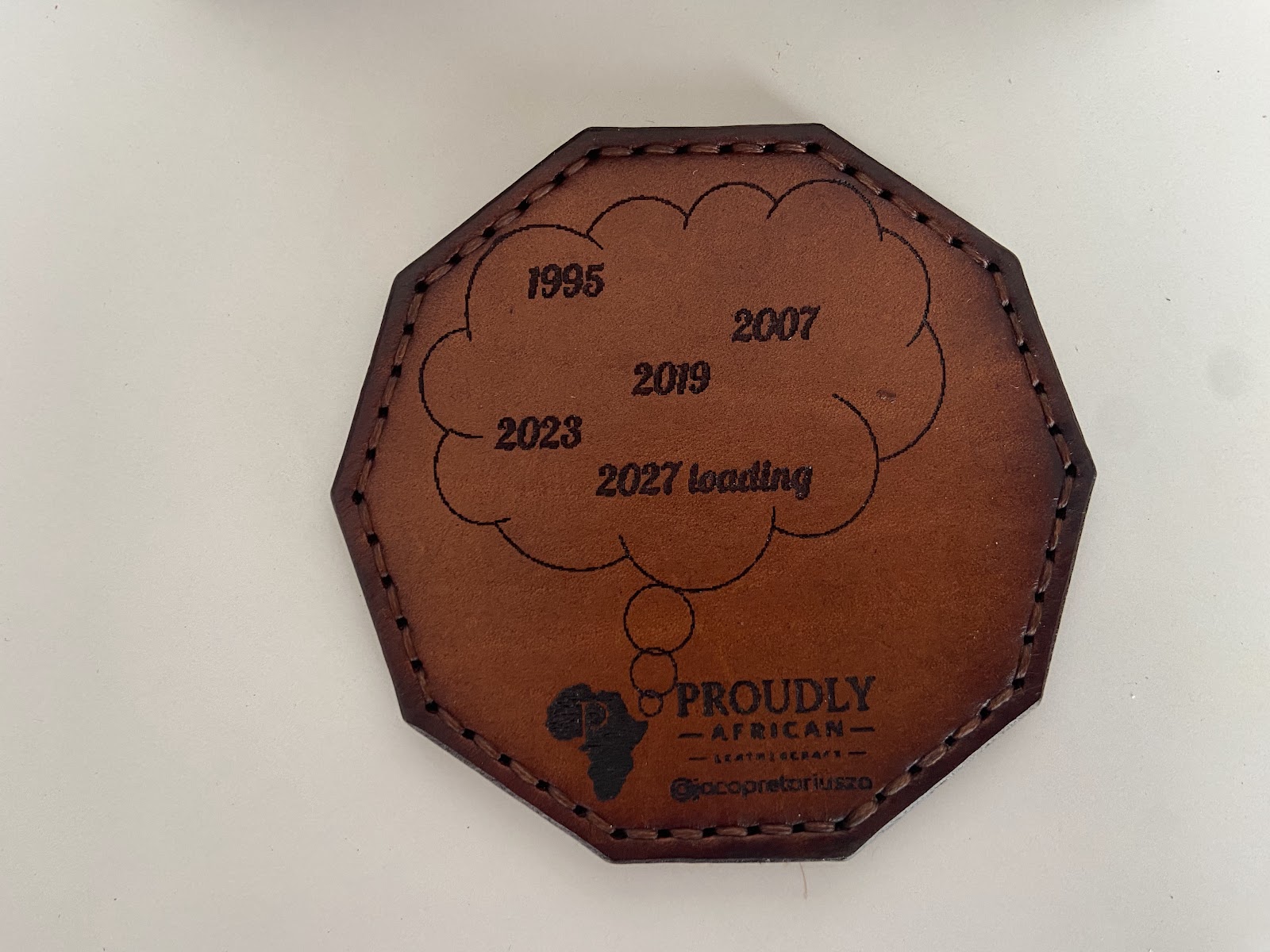 Commemorative leather coaster with stamped dates