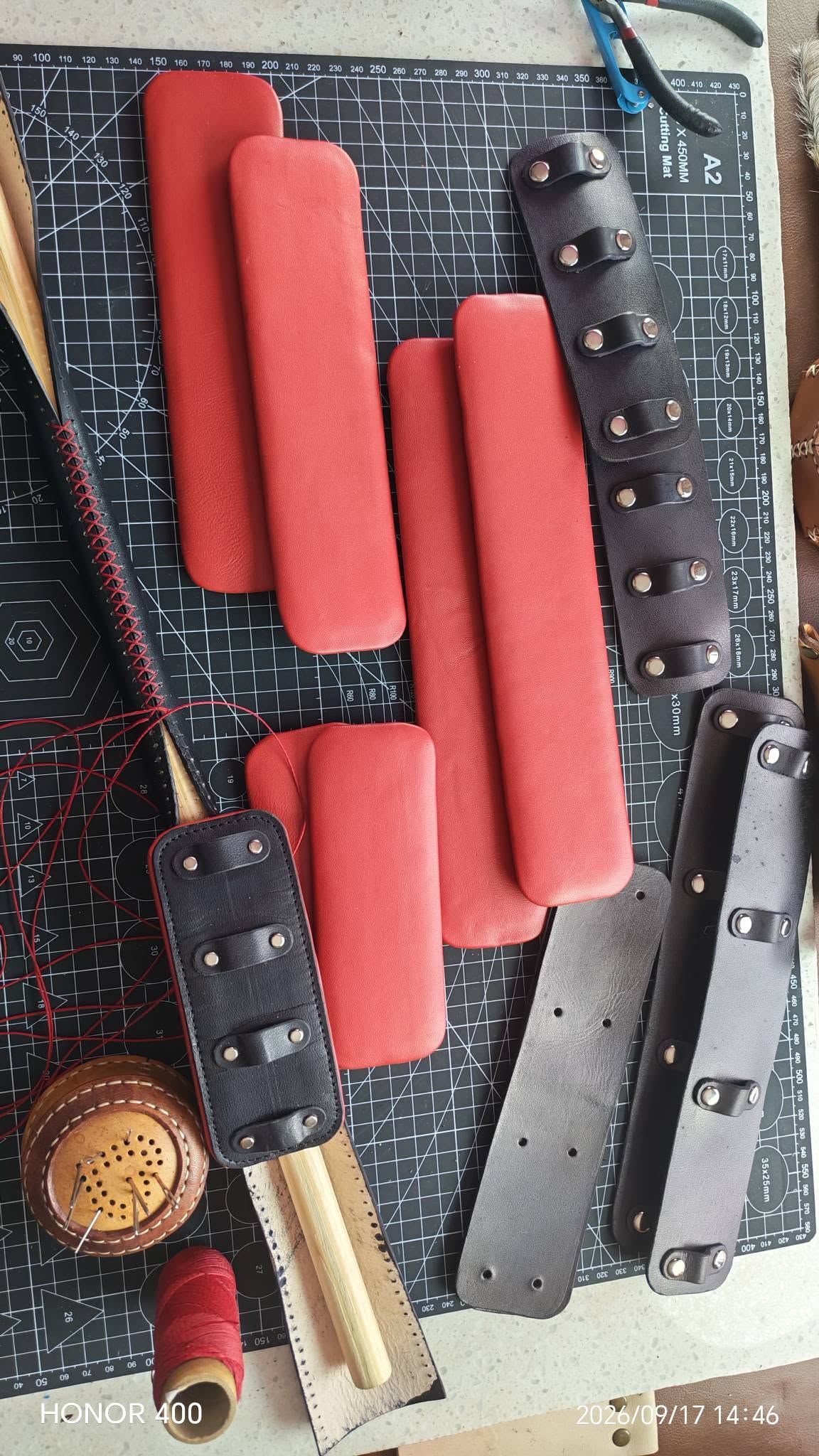Custom intimate leather set with red padded pieces and black buckled straps