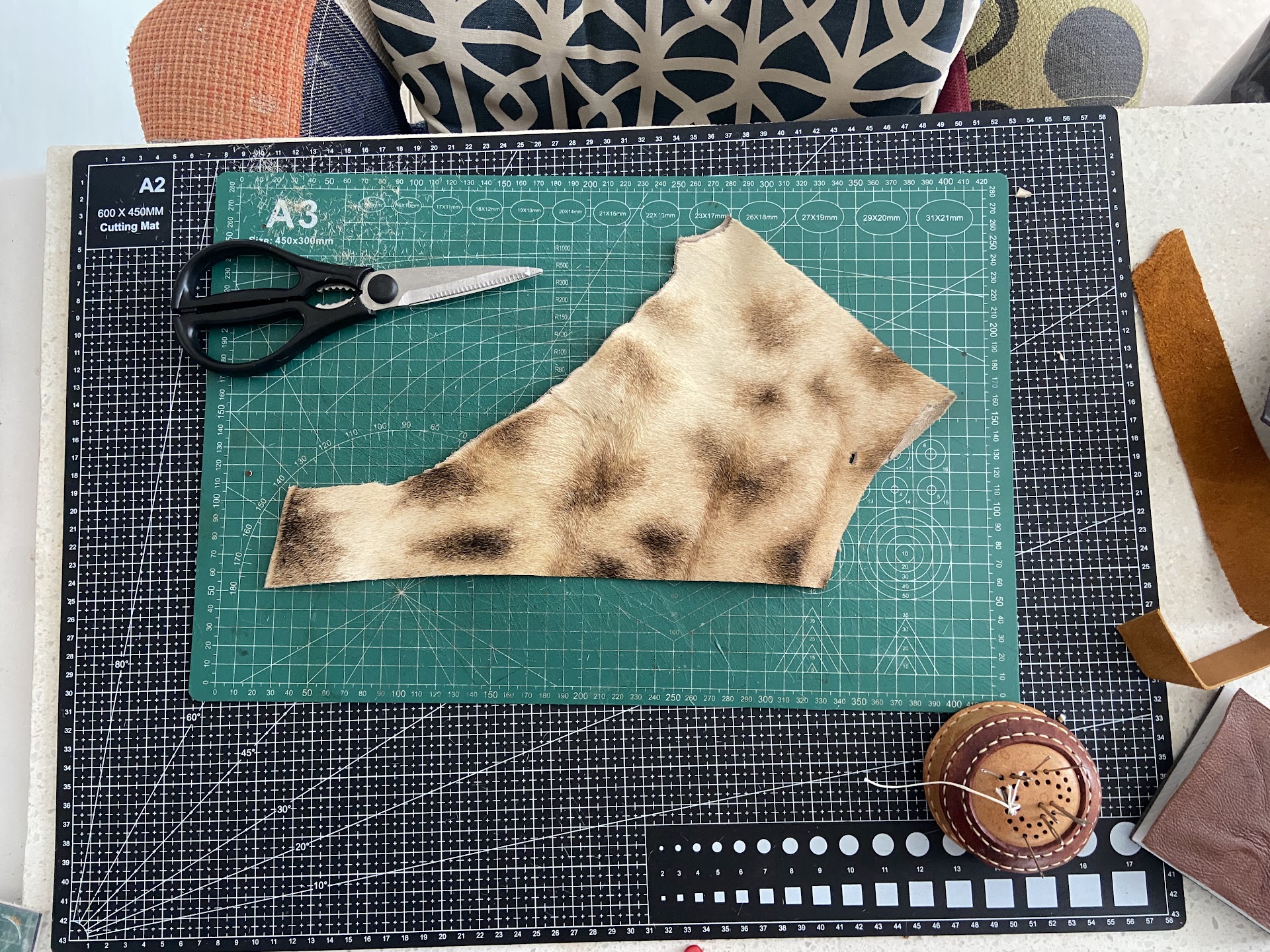 Leather, scissors and a ruler on Jaco's cutting mat