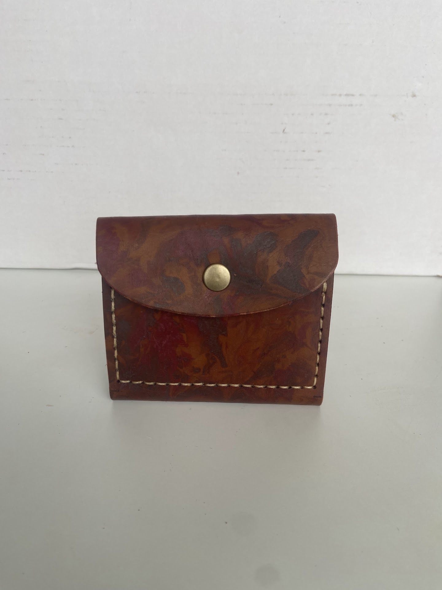 Hand-stitched leather card holder with a press stud