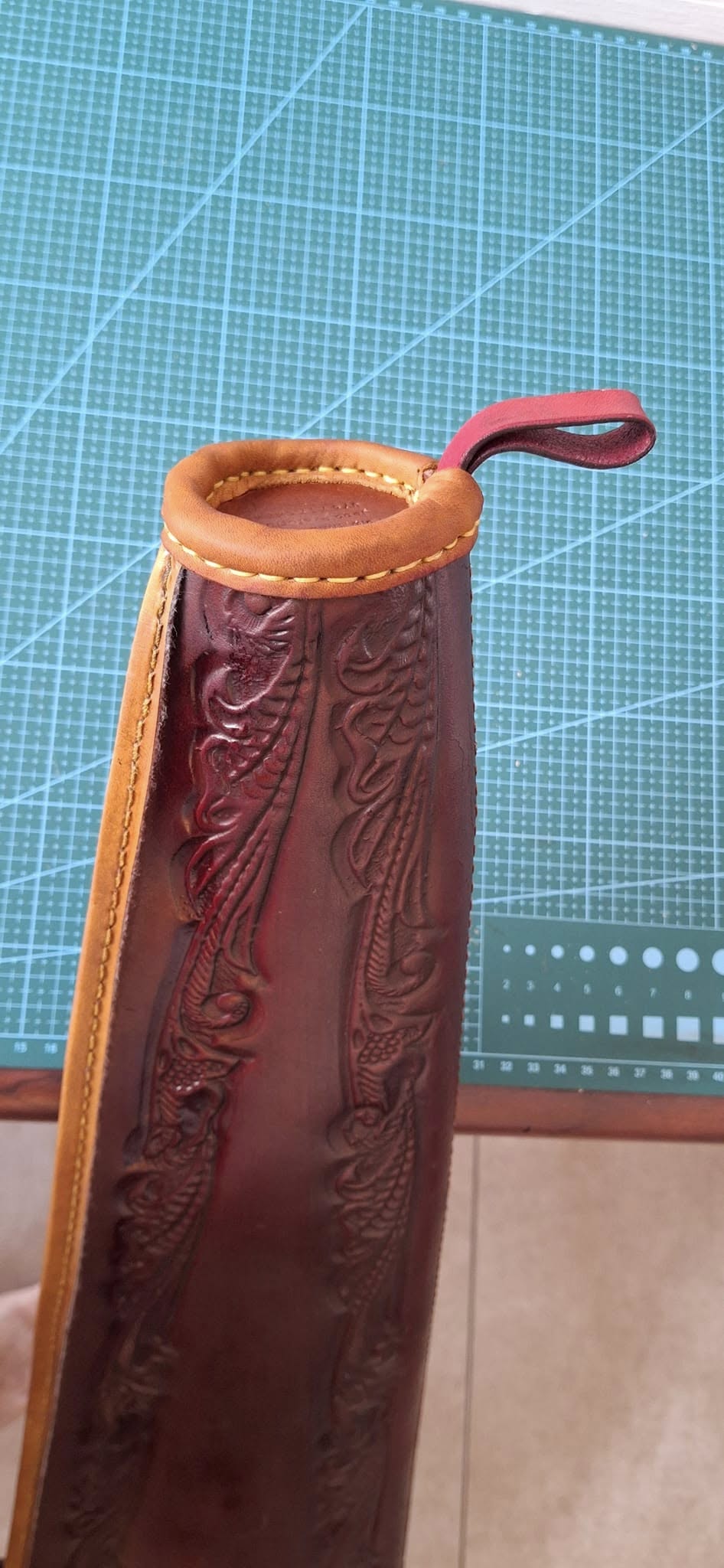 Restored leather quiver with floral tooling and a stitched tan rim