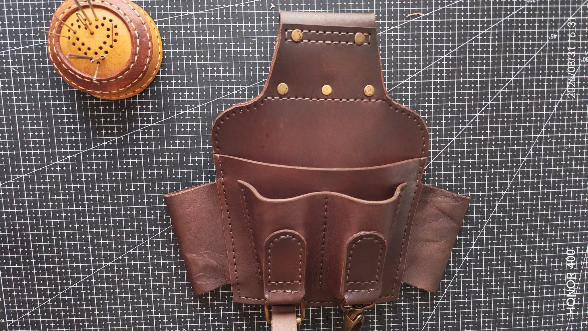 Stitched leather belt pouches and a holster