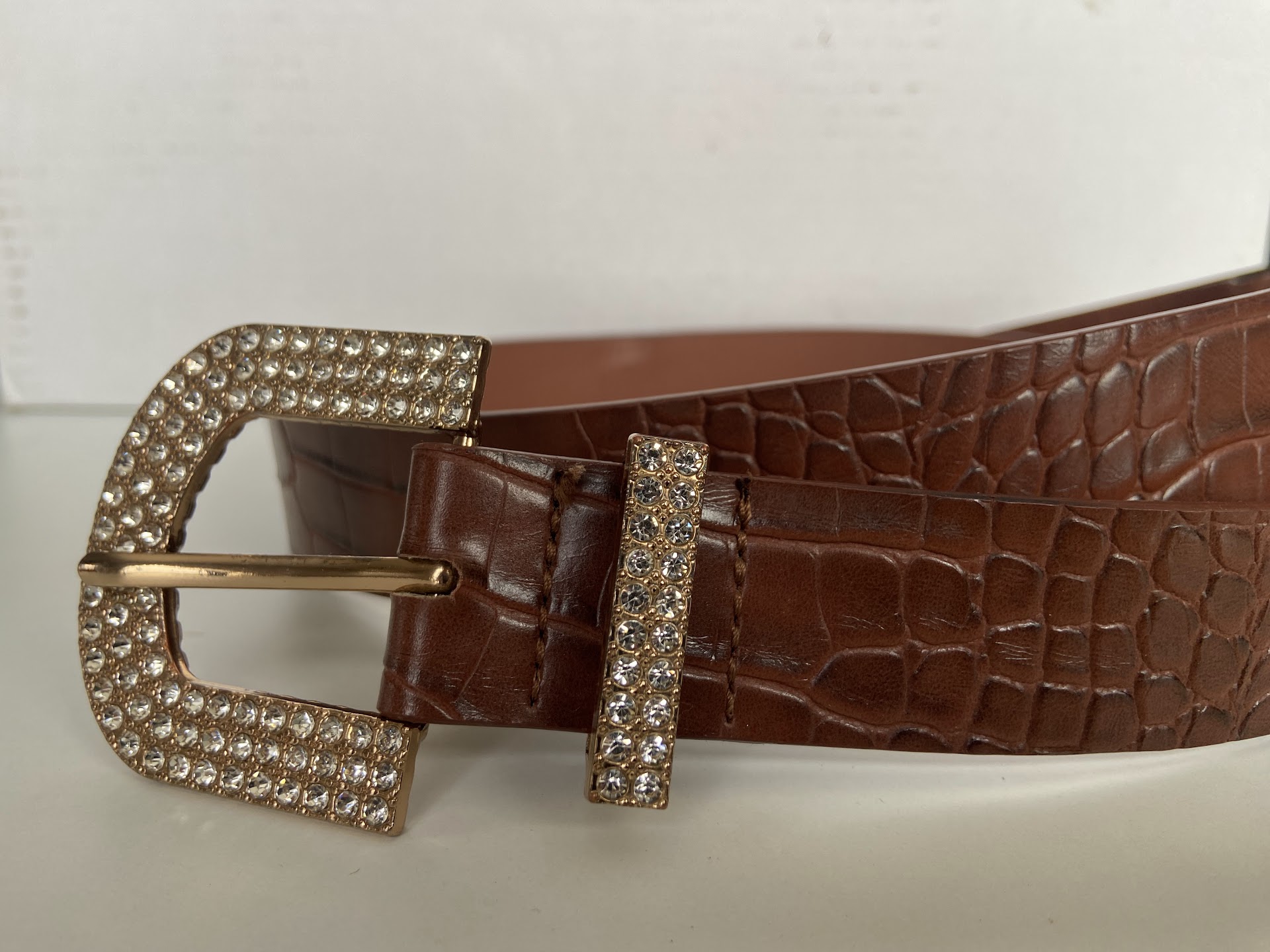 Close-up of Jaco's croc-embossed leather belt with its ornate buckle
