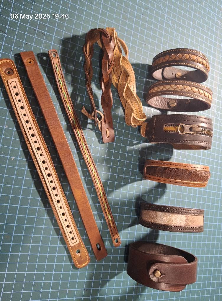 Coiled leather belts and stitched cuffs