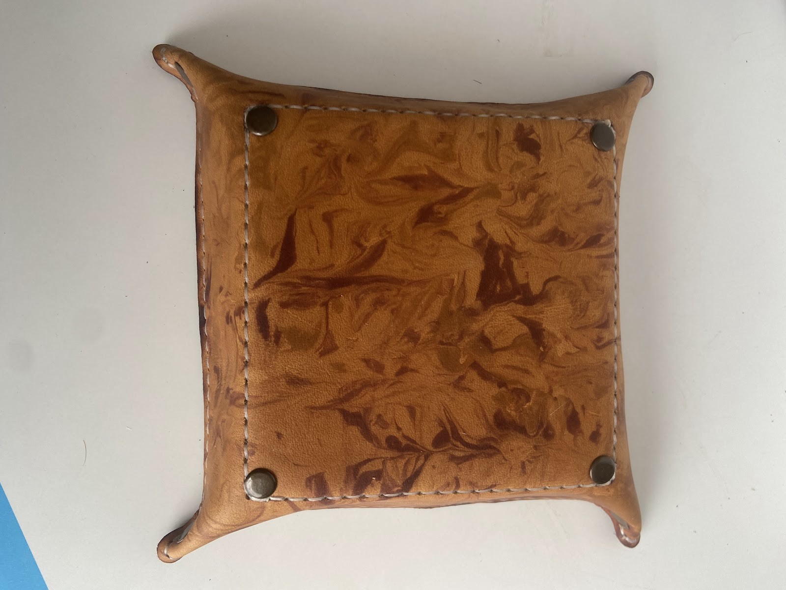 Floral tooled tan leather tray with hand-stitched edges